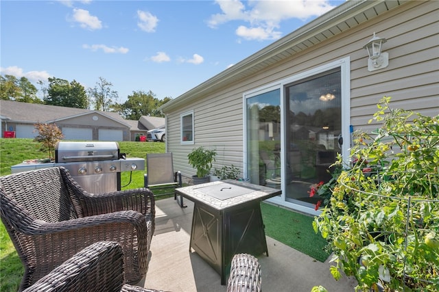 view of patio / terrace featuring grilling area and a garage