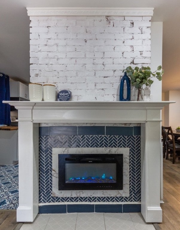 details featuring wood-type flooring and a tiled fireplace