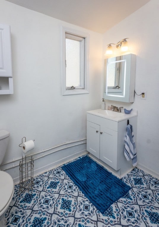 bathroom with vanity and toilet