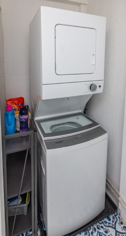 clothes washing area featuring stacked washer and dryer