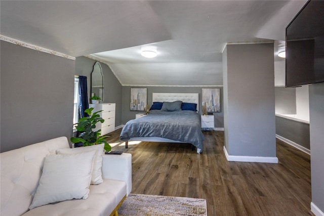 bedroom featuring dark wood-type flooring and lofted ceiling