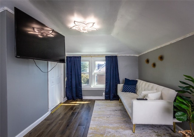 unfurnished room featuring lofted ceiling, crown molding, and hardwood / wood-style flooring