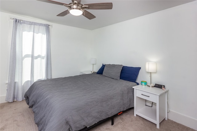 bedroom featuring light carpet and ceiling fan