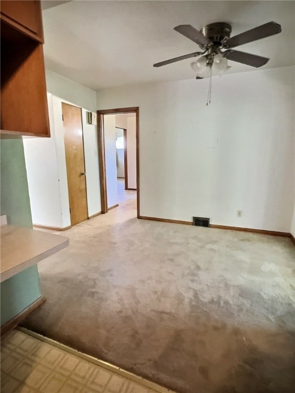 carpeted spare room with ceiling fan