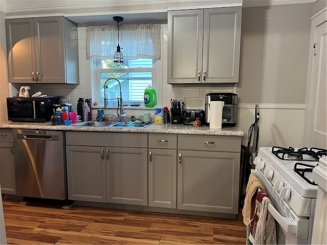 kitchen with dishwasher, white gas range oven, dark hardwood / wood-style floors, and gray cabinets