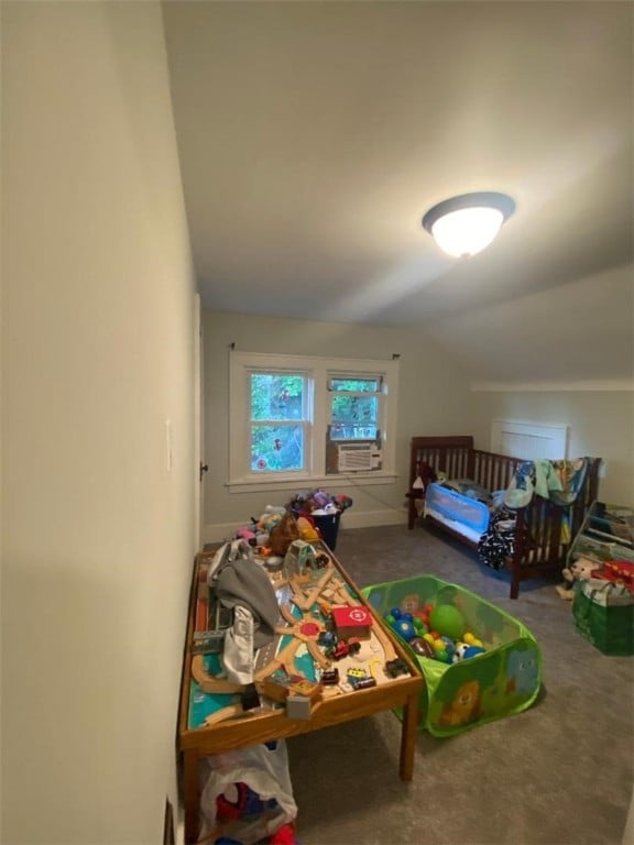 bedroom with carpet floors and vaulted ceiling