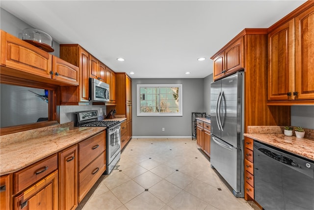 kitchen with light stone counters and stainless steel appliances