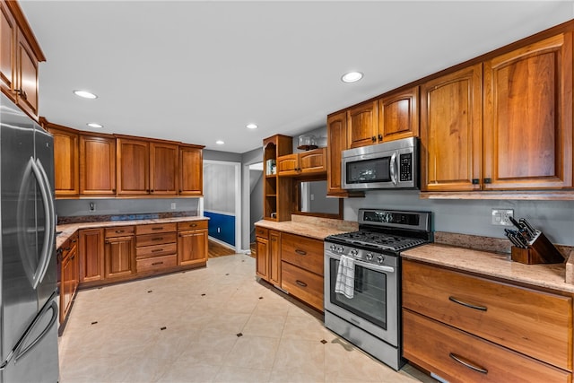 kitchen featuring light stone counters and appliances with stainless steel finishes