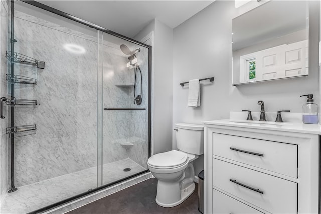 bathroom with an enclosed shower, vanity, and toilet