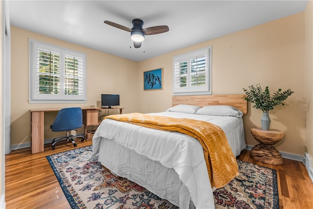 bedroom with ceiling fan and wood-type flooring