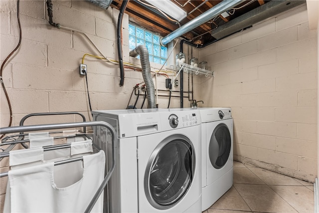 laundry area featuring light tile patterned flooring and washer and dryer