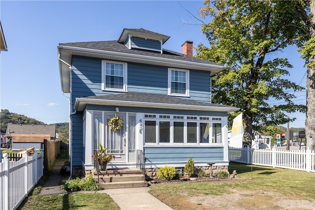 front facade featuring a front yard