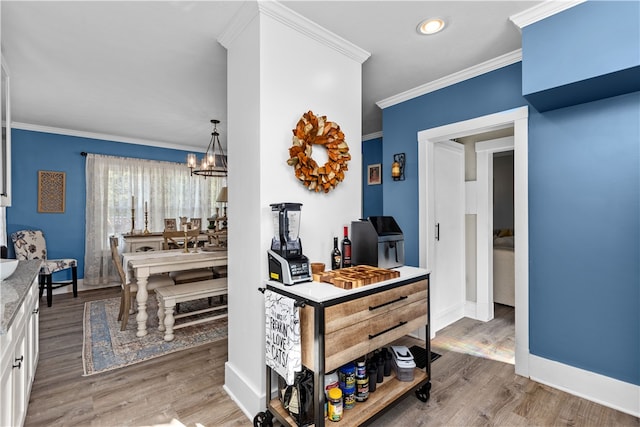 interior space with crown molding, hardwood / wood-style floors, and a notable chandelier