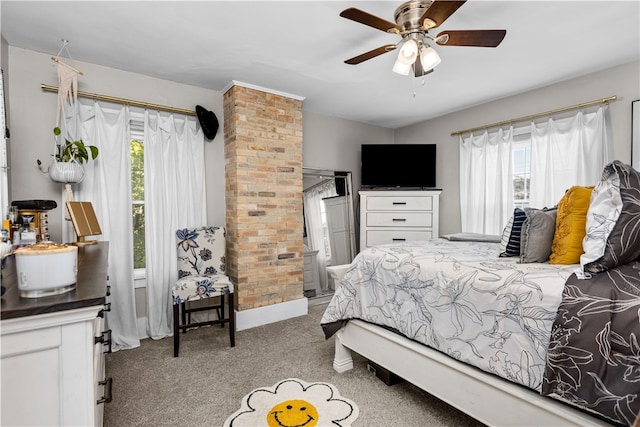 bedroom with light colored carpet, multiple windows, and ceiling fan