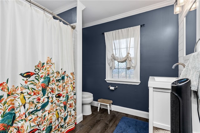 bathroom featuring wood-type flooring, crown molding, vanity, and toilet