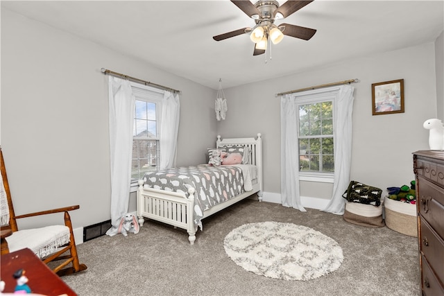 carpeted bedroom with multiple windows and ceiling fan