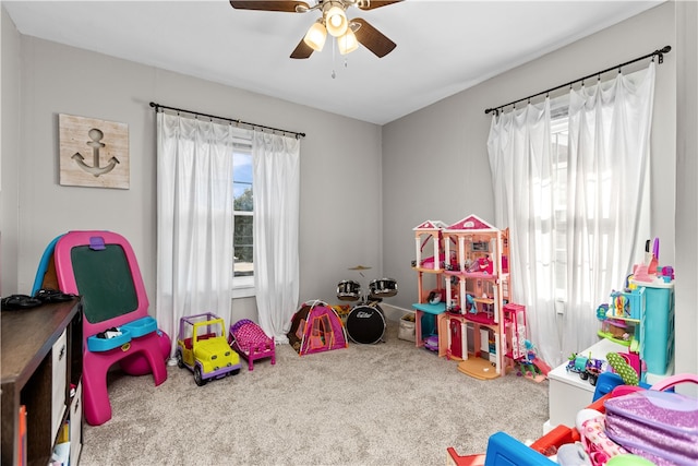 recreation room with carpet flooring and ceiling fan