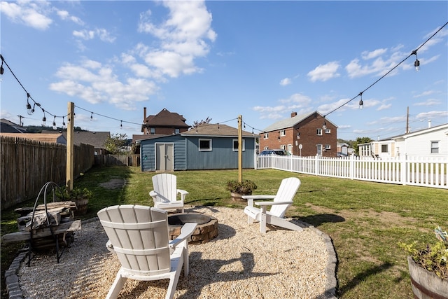 view of yard with an outdoor fire pit and a storage shed