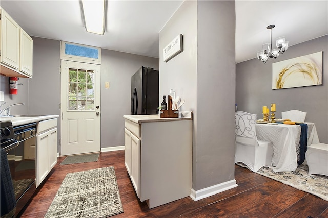 kitchen featuring black appliances, white cabinetry, dark wood-type flooring, and sink