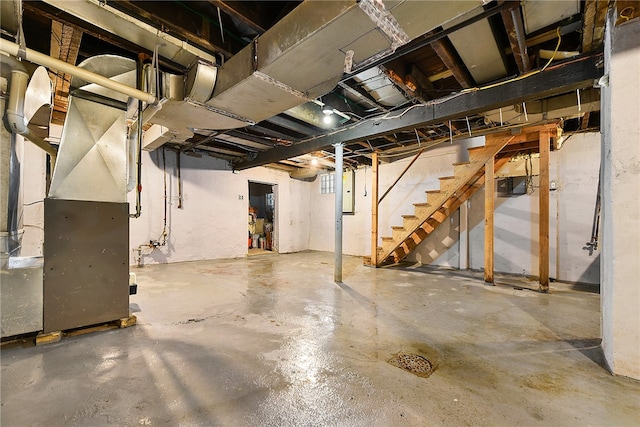 basement with electric panel and heating unit