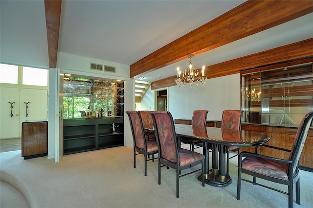 carpeted dining area featuring beamed ceiling, a chandelier, and bar