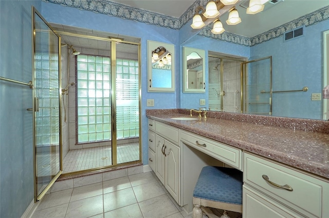 bathroom with an enclosed shower, tile patterned flooring, and vanity