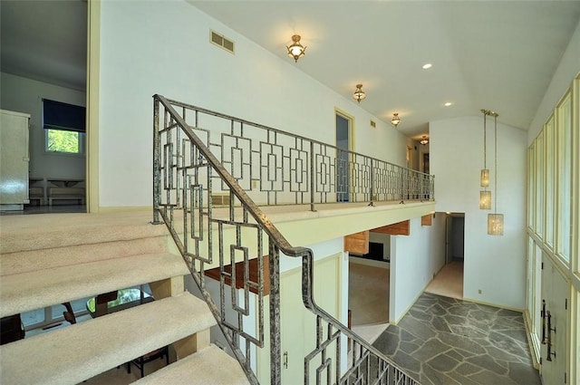 stairway featuring vaulted ceiling, carpet, baseboards, and recessed lighting