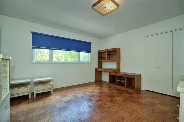 interior space featuring a closet and dark parquet floors