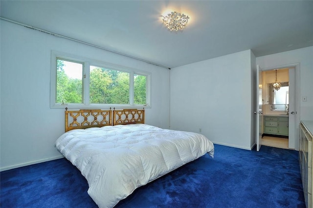 bedroom with dark colored carpet and baseboards