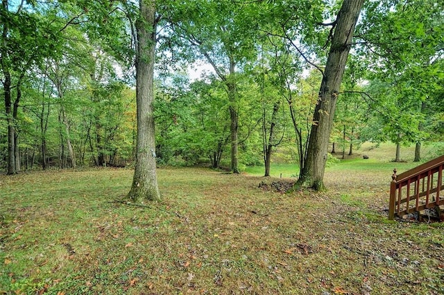 view of yard with a view of trees