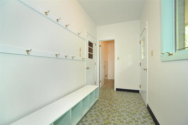 mudroom with light floors and baseboards