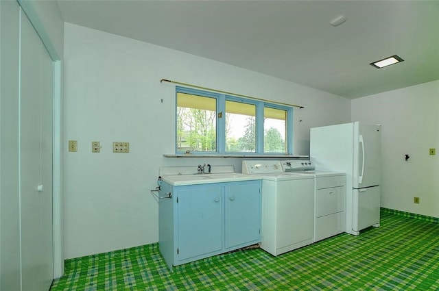 kitchen featuring light colored carpet, washer and clothes dryer, light countertops, and freestanding refrigerator