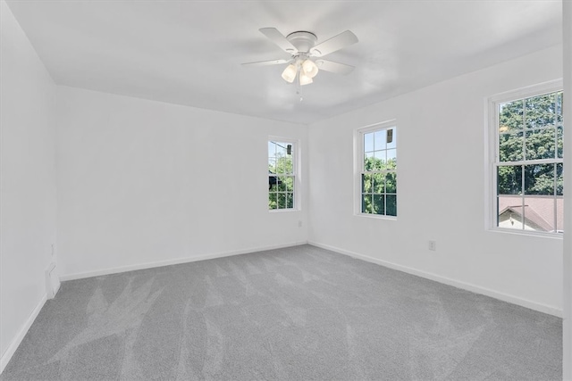 unfurnished room featuring ceiling fan and carpet flooring