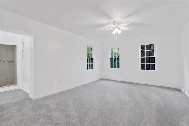 unfurnished room with ceiling fan and light carpet