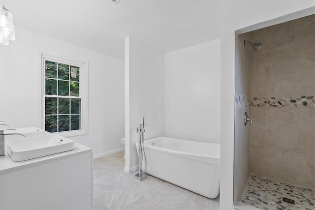 full bathroom featuring shower with separate bathtub, vanity, and toilet