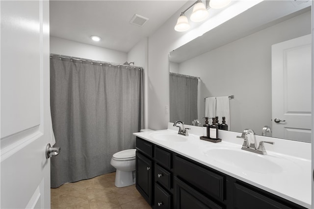 bathroom with curtained shower, tile patterned floors, vanity, and toilet