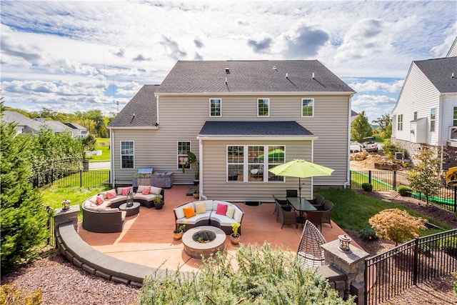 back of property featuring an outdoor living space with a fire pit and a patio