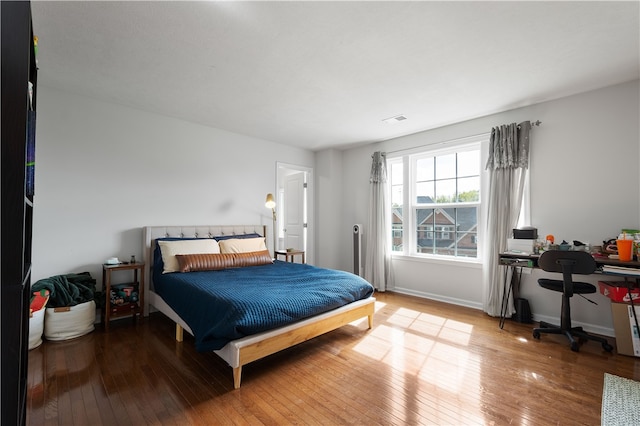 bedroom with wood-type flooring