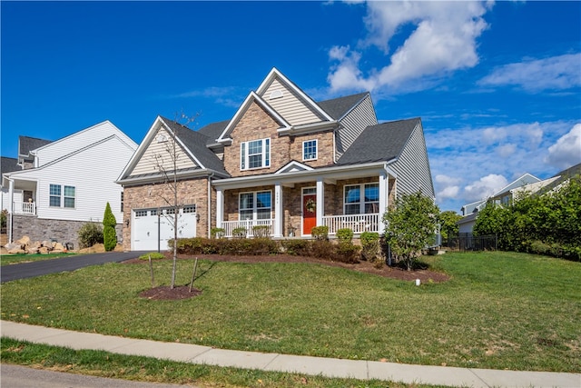 craftsman-style house featuring a garage, a porch, and a front yard