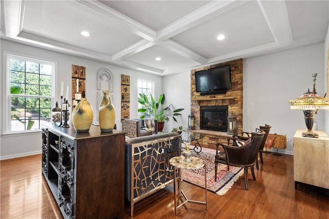 living room featuring a fireplace, coffered ceiling, hardwood / wood-style floors, and beamed ceiling