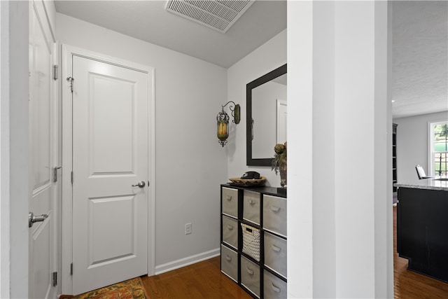 hallway with dark hardwood / wood-style floors