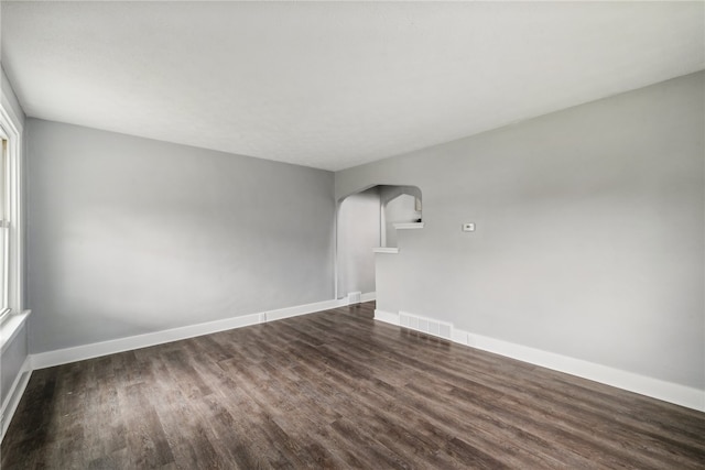 unfurnished room featuring dark wood-type flooring