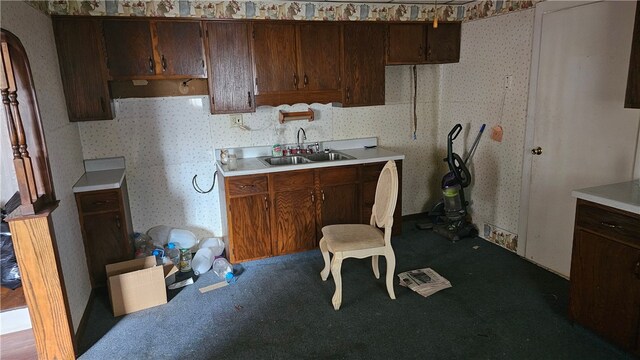 255-1 School Ave, Conemaugh Twp Som, PA 15937 - kitchen with a sink, wallpapered walls, carpet flooring, light countertops, and dark brown cabinets