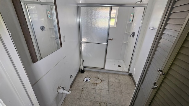 bathroom featuring a shower with door