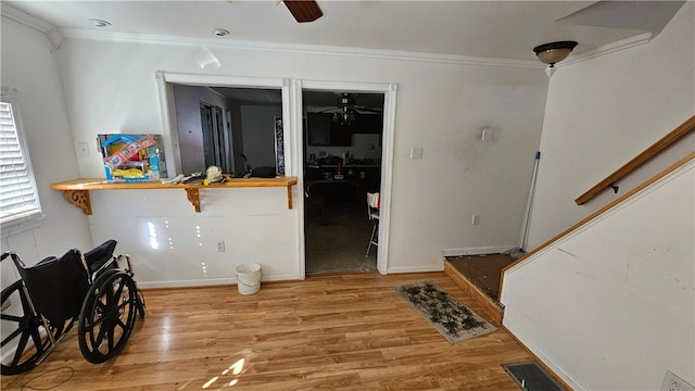 interior space featuring ceiling fan, ornamental molding, and hardwood / wood-style floors