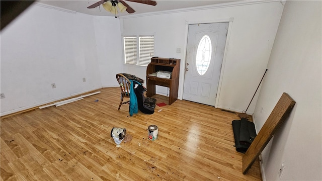 foyer entrance featuring crown molding, ceiling fan, and wood-type flooring