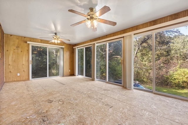 unfurnished sunroom featuring ceiling fan