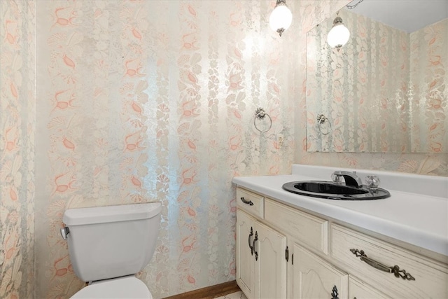 bathroom featuring vanity and toilet