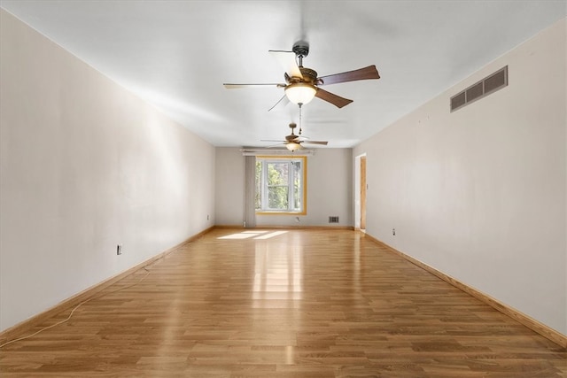 empty room with light wood-type flooring and ceiling fan