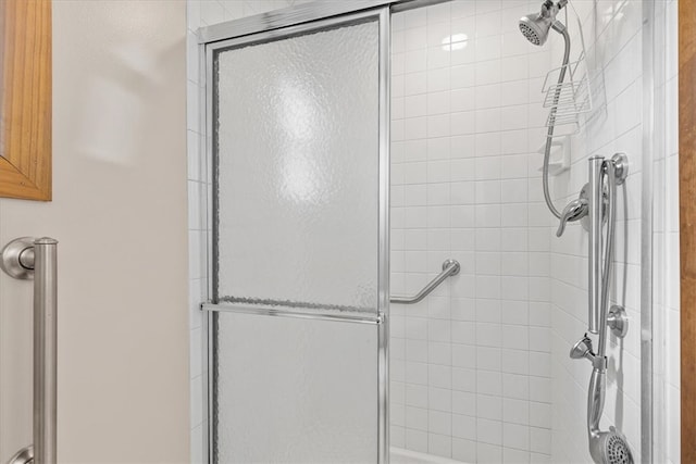 bathroom featuring a shower with shower door